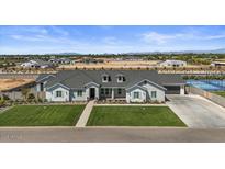 Beautiful single-Gathering home boasting manicured lawn, stone accents, and a three-car garage in a well-planned community at 18826 E Augusta Ave, Queen Creek, AZ 85142
