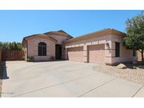 Charming single-story home with a three-car garage and well-maintained front yard at 26814 N 65Th Dr, Phoenix, AZ 85083