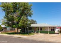 Charming single-story home with a spacious front yard and mature tree providing shade at 2926 W San Miguel Ave, Phoenix, AZ 85017