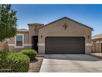 Charming single-story home featuring a two-car garage and beautifully landscaped front yard at 30238 N Ocotillo Dr, Florence, AZ 85132