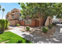 Charming townhome exterior with landscaped front yard and private balcony at 3600 N Hayden Rd # 3002, Scottsdale, AZ 85251