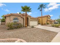 Charming single-story home with desert landscaping, palm trees and a tile roof at 3711 E Long Lake Rd, Phoenix, AZ 85048