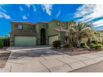 Inviting two-story home boasts three-car garage and meticulously landscaped front yard, perfect for curb appeal at 4413 E Odessa Dr, San Tan Valley, AZ 85140