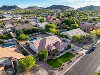 Expansive aerial view of home with desert landscaping, private pool, and mountain views at 4637 W Misty Willow Ln, Glendale, AZ 85310