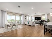 Spacious open-concept living area featuring hardwood floors, modern decor, and a dining area at 5100 E Rancho Paloma Dr # 2065, Cave Creek, AZ 85331