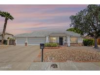 Charming single-story home featuring a three-car garage and desert landscaping for low maintenance at 5944 W Greenbriar Dr, Glendale, AZ 85308