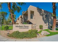 Well-maintained Winfield Place Condominiums with manicured landscaping and inviting signage at 7436 E Chaparral Rd # B246, Scottsdale, AZ 85250