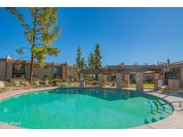 Resort-style pool with lounge chairs and shaded pergola, perfect for relaxation and recreation at 7436 E Chaparral Rd # B246, Scottsdale, AZ 85250