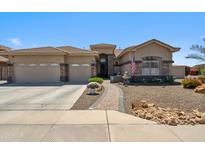 Charming single-story home with a well-manicured front yard, three-car garage, and inviting curb appeal at 11013 E Decatur St, Mesa, AZ 85207