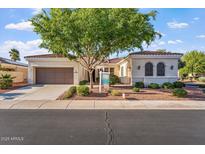 Charming single-story home with a red tile roof, landscaped front yard, and a spacious two-car garage at 12820 W La Vina Dr, Sun City West, AZ 85375