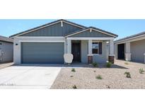 Charming single-Gathering home featuring a desert landscape, a two-car garage and a covered front entryway at 18219 W Daley Ln, Surprise, AZ 85387