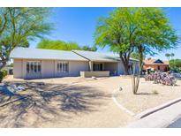 Charming single-story home with desert landscaping, mature trees, and a circular driveway at 2935 W Kristal Way, Phoenix, AZ 85027