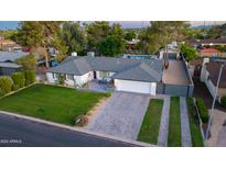 Aerial view of single-story home with a large yard, block fence, gated driveway and private backyard pool at 3027 W Wescott Dr, Phoenix, AZ 85027