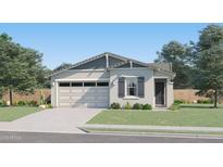 Charming single-story home with a well-manicured lawn, a two-car garage and beautiful desert landscaping at 3238 E Outlaw Ln, San Tan Valley, AZ 85140