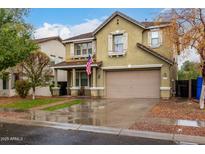 Two-story home with neutral colored stucco, American flag, covered entry, and landscaped yard at 3432 E Bartlett Dr, Gilbert, AZ 85234
