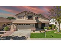 Charming two-story home featuring a well-manicured lawn, a two-car garage, and a welcoming facade at 3478 E Park Ave, Gilbert, AZ 85234
