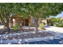 Charming single-story home with desert landscaping and a porte-cochere for covered parking at 3649 E Hutchins Ct, Gilbert, AZ 85295