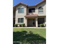 Inviting townhouse featuring well-maintained landscaping and classic architectural details with a red tiled entryway at 3930 W Monterey St # 136, Chandler, AZ 85226