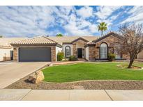 Charming single-story home with stone accents, tile roof, well-maintained lawn, and mature landscaping at 4214 E Morrow Dr, Phoenix, AZ 85050