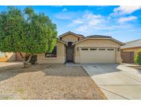 Charming single-story home with a well-maintained yard and a two-car garage with beautiful desert landscaping at 6843 S 46Th Dr, Laveen, AZ 85339