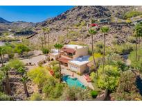 An aerial view of a desert estate showcasing a sparkling pool, lush landscaping, and red tile roof at 7131 N 40Th St, Paradise Valley, AZ 85253