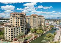 Stunning aerial view of waterfront property and community featuring palm trees and cityscape views at 7175 E Camelback Rd # 510, Scottsdale, AZ 85251