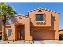 Charming two-story home featuring a stucco exterior, a terracotta roof, and a well-manicured front yard with desert landscaping at 7204 S Golfside Ln, Phoenix, AZ 85042