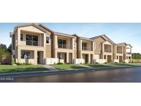 Charming townhomes with neutral exteriors, complemented by wrought iron balconies and well-manicured landscaping at 8149 E Petunia Ave # 1042, Mesa, AZ 85212