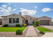 Charming single-story home with a tiled roof, manicured lawn, and brick pathway at 9281 W Villa Chula --, Peoria, AZ 85383
