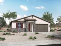 Charming single-story home featuring stone accents, desert landscaping, and a two-car garage at 12721 W Corona Ave, Avondale, AZ 85323