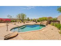 Backyard pool with waterfall feature and mature landscaping at 15107 E Desert Willow Dr, Fountain Hills, AZ 85268
