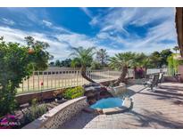 Beautiful outdoor patio with brick pavers, charming water feature, and sunny views at 17162 N Winding Trl, Surprise, AZ 85374
