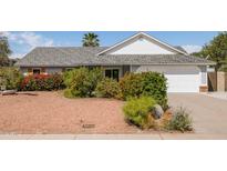 Charming single-story home with well-maintained landscaping and a two-car garage at 1810 N Sunaire Cir, Mesa, AZ 85205