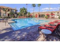 Resort-style pool with lounge chairs and palm trees at 1941 S Pierpont Dr # 1099, Mesa, AZ 85206