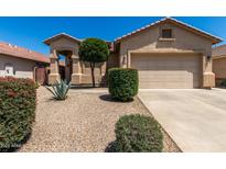 Charming single-story home featuring low-maintenance landscaping and a two-car garage at 21563 N Greenway Rd, Maricopa, AZ 85138
