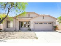 Charming single-story home with a two-car garage and desert landscaping under a clear, sunny sky at 2401 W Ellis St, Phoenix, AZ 85041