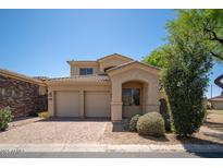Charming two-story home with a three-car garage and a well-manicured front yard in a sunny neighborhood at 2406 N 142Nd Ave, Goodyear, AZ 85395