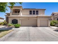 Charming two-story home with a three-car garage and a beautiful balcony under clear blue sky at 7217 S Hazelton Ln, Tempe, AZ 85283