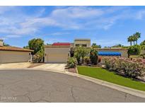 Striking exterior view of home with desert landscaping, mature trees and attached three-car garage at 9241 S 50Th St, Phoenix, AZ 85044