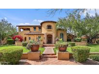 Mediterranean-style home featuring a terracotta roof, landscaped yard, and charming architectural details at 10182 E Gilded Perch Dr, Scottsdale, AZ 85255