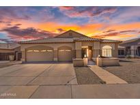 Charming single-story home boasts a three-car garage and beautiful desert landscaping at 10809 W Harmony Ln, Peoria, AZ 85373