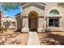 Inviting front entrance of the property features desert landscaping, an arched entryway, and a large window at 1111 W Summit Pl # 85, Chandler, AZ 85224