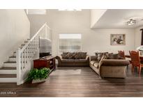 Bright living room with high ceilings, wood floors, staircase, and comfortable seating at 11429 W Yavapai St, Avondale, AZ 85323