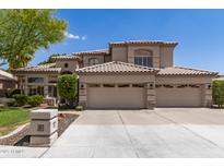 Stunning two-story home featuring a three-car garage, tile roof, and well-maintained landscaping at 1181 N Dustin Ln, Chandler, AZ 85226