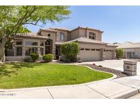 Charming two-story home boasts a lush green lawn, mature trees, and a three-car garage at 1181 N Dustin Ln, Chandler, AZ 85226