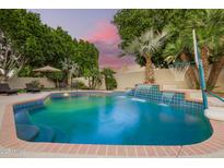 Beautiful pool featuring a waterfall and mature landscaping, perfect for relaxation and entertainment at 1181 N Dustin Ln, Chandler, AZ 85226