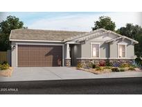 Charming one-story home with a two-car garage, stone accents, and a beautifully landscaped front yard at 17703 W Ford St, Goodyear, AZ 85338