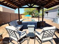 Inviting backyard patio with a cozy seating area and a view of the refreshing pool at 17913 E Watford Dr, Queen Creek, AZ 85142
