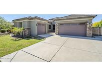 Charming home featuring a two-car garage, meticulous landscaping, and a well-maintained concrete driveway at 18617 E Arrowhead Trl, Queen Creek, AZ 85142