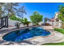 Beautiful pool area with shimmering blue water, surrounded by lush greenery and a basketball hoop at 2028 S Esmeralda --, Mesa, AZ 85209